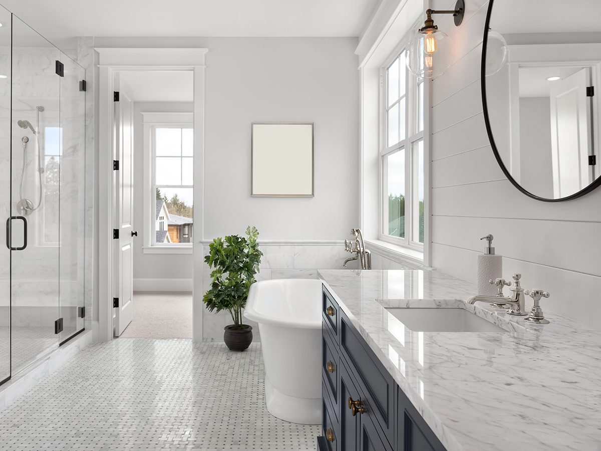 A modern bathroom featuring a spacious tub and a sleek shower, showcasing a clean and inviting design.